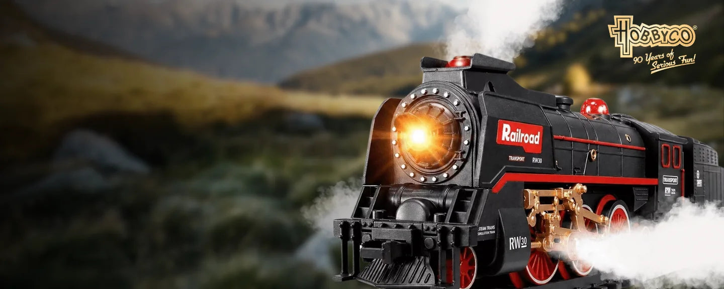 A red and black steam locomotive travelling through a mountain landscape.