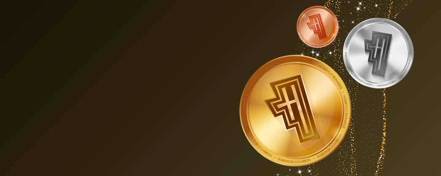 Bronze, silver and gold Hobbycoins against a dark gold background.